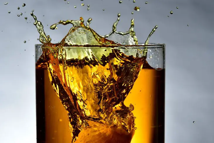 clear drinking glass filled with brown liquid