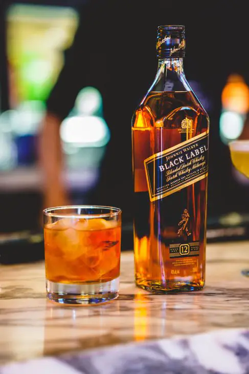 A lovely cocktail called the Johnnie Black Box Office, prepared with Johnnie Walker Black Label and Vermouth.