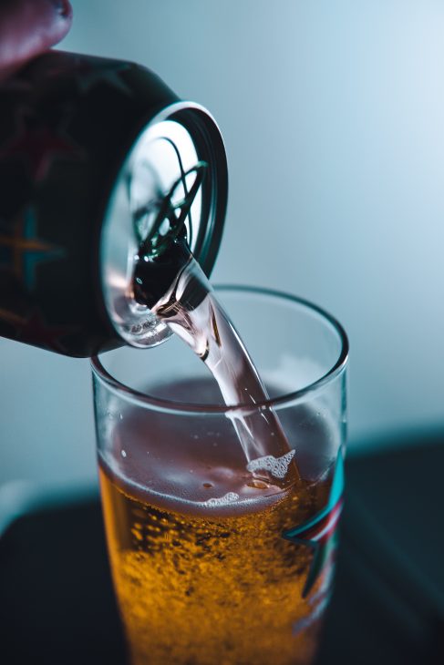 clear shot glass with brown liquid