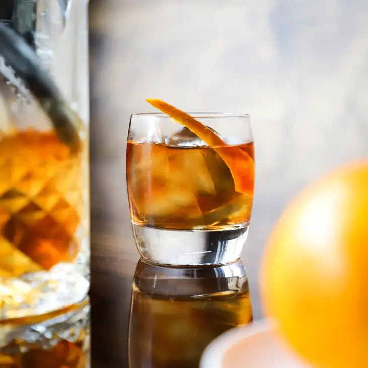 Bourbon cocktail with orange garnish